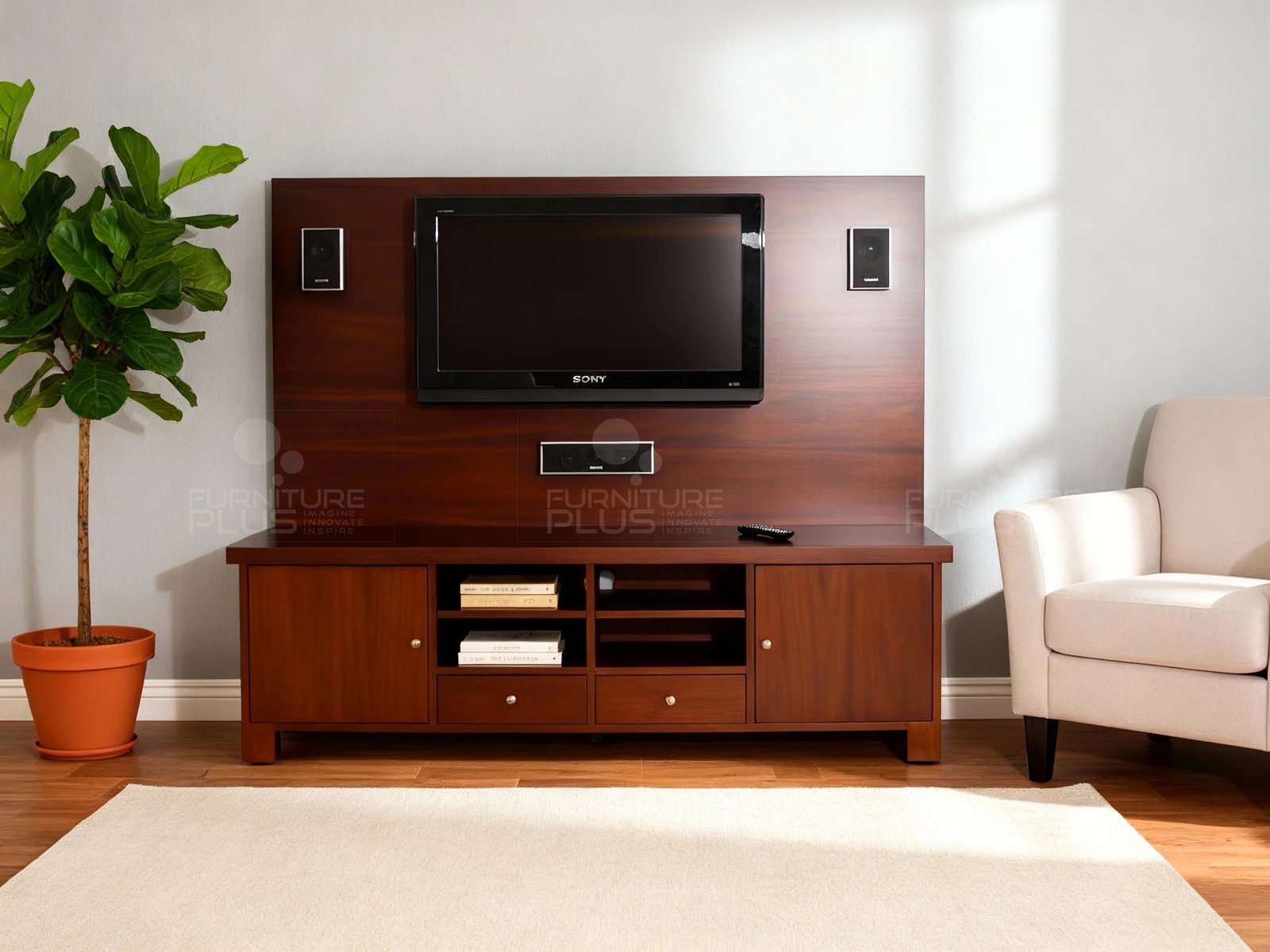 A traditional style Avatar multimedia unit in a staged living room with a light gray wall. The rich mahogany-colored unit features a wide TV console with two cabinets, open shelves, and two drawers. A large wooden back panel rises from the console, mounting a television and three black speakers. A potted fiddle-leaf fig tree stands to the left, and a cream armchair is visible on the right, all resting on a wood floor with a neutral area rug