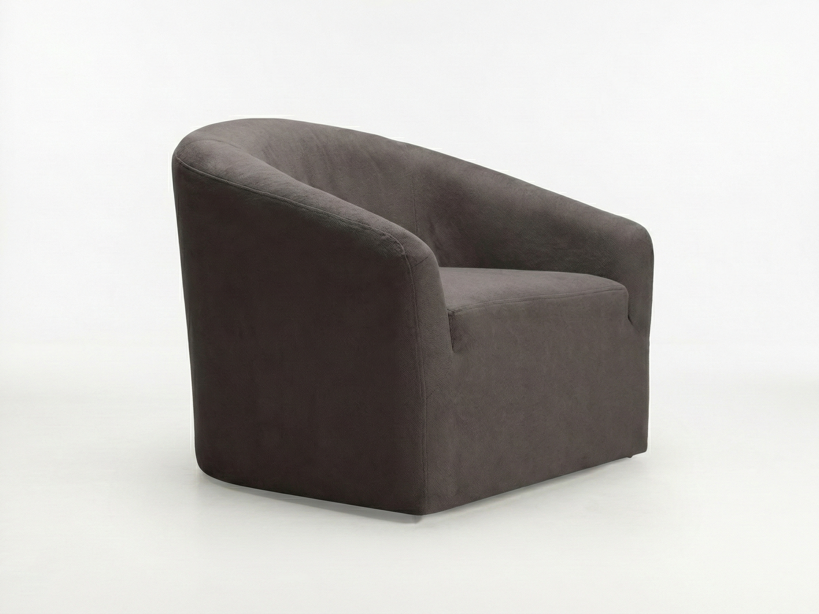 Side view of the Bentley Easy Chair, a fully upholstered tub-style armchair with a deep, curved back and integrated armrests. The chair is covered in dark gray or charcoal fabric, with a smooth, continuous shape, and is sitting on a plain white or light gray floor