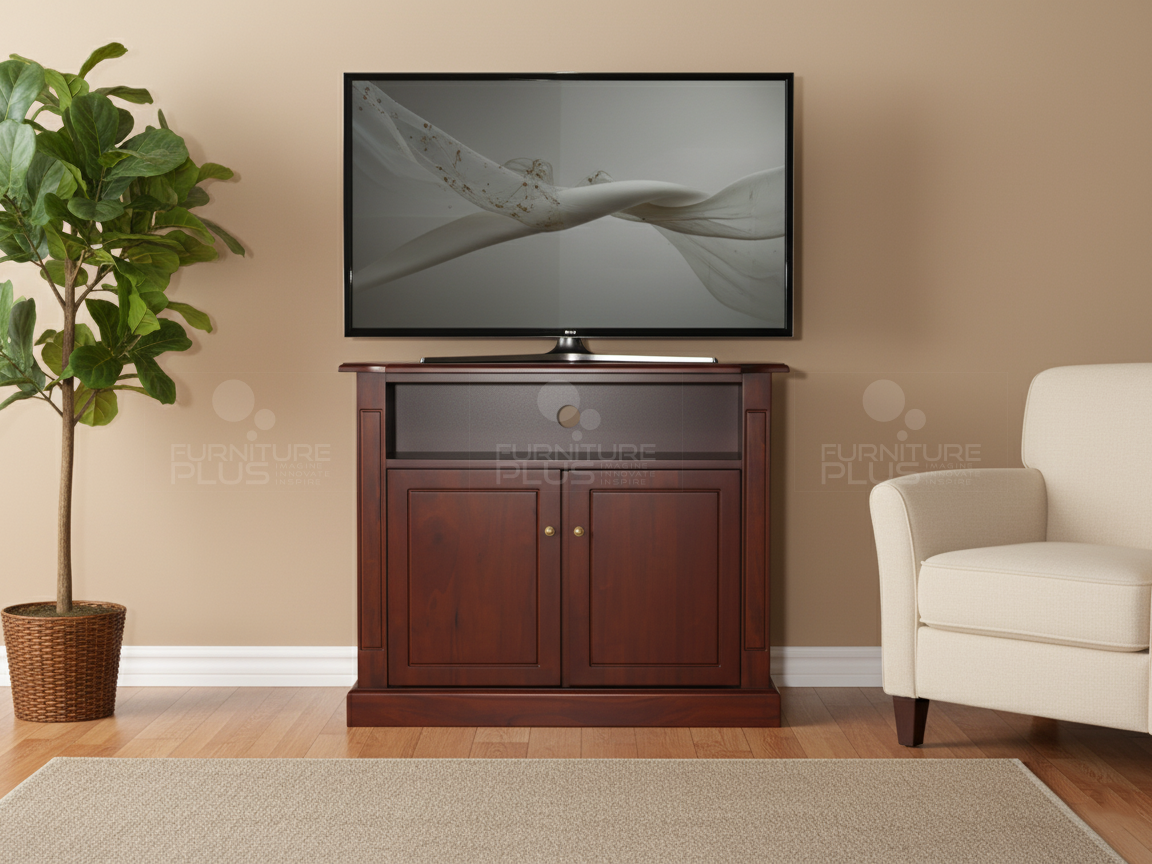 A small, traditional mahogany Casablanca TV cabinet with two doors and an open shelf, positioned against a light tan wall. A flat-screen television sits on top of the cabinet. The unit is flanked by a potted fiddle-leaf fig tree on the left and a cream-colored armchair on the right, all on a hardwood floor with a neutral area rug