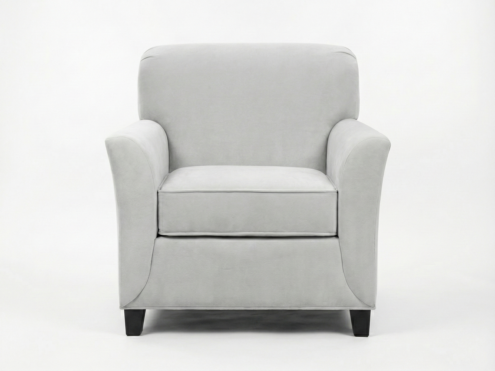Front view of the Delia Arm Chair, a contemporary, fully upholstered easy chair in light gray fabric. It features a squared back with gently rolled corners, subtle flared armrests, and a thick, removable seat cushion with piping detail. The chair sits on short, dark block feet against a plain white background