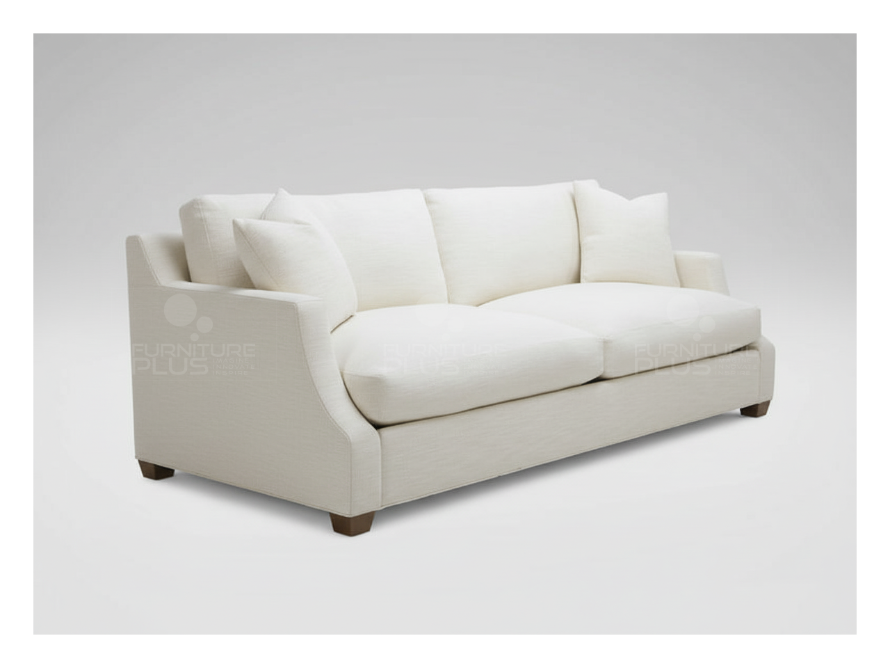 Side view of Hamilton fully upholstered white three seater sofa with curved arms and two white throw pillows