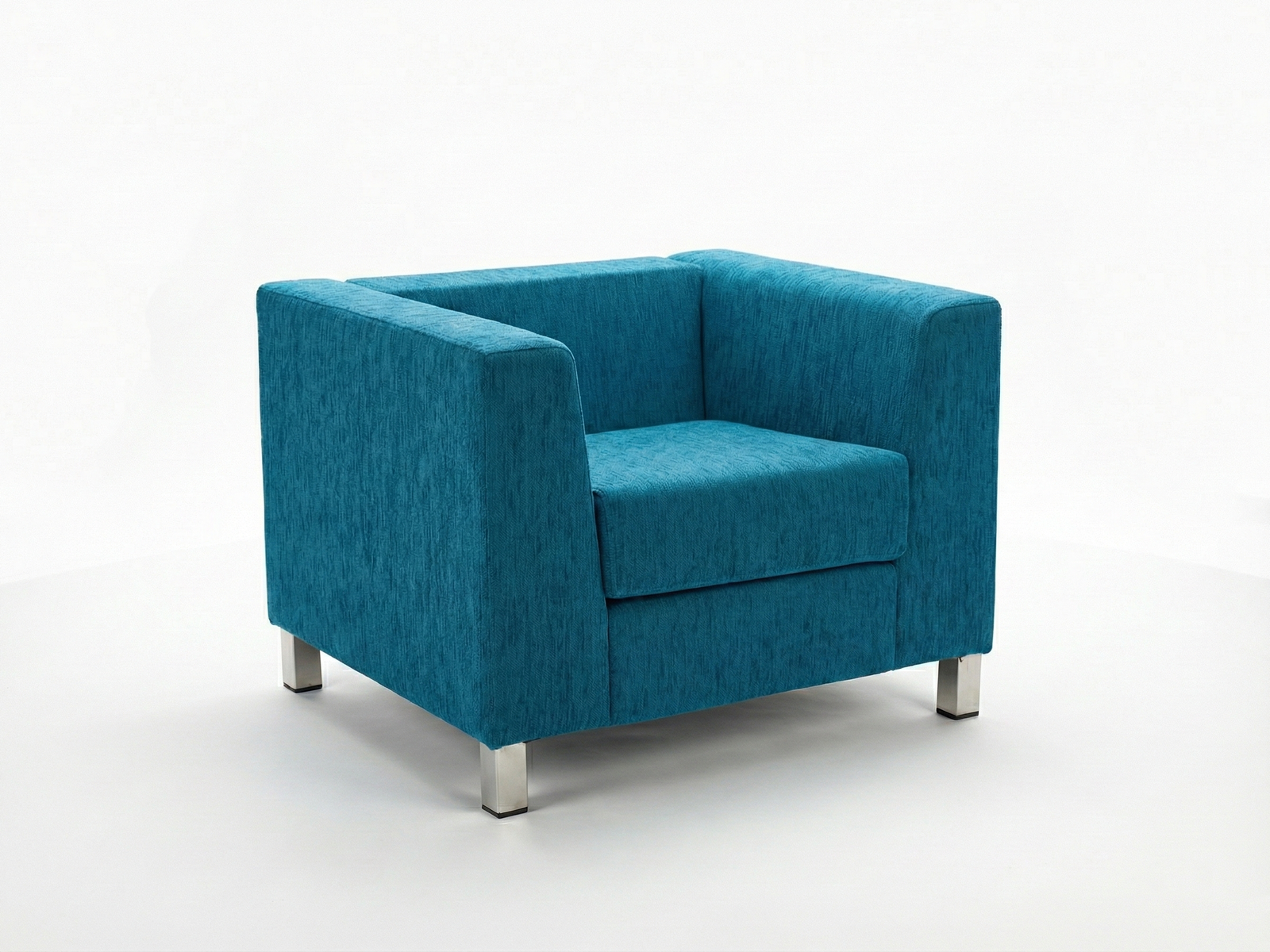 Side view of the Kim Easy Chair, a modern, boxy armchair fully upholstered in a textured, bright teal or turquoise fabric. It features a squared back, straight track arms, and a deep seat cushion. The chair stands on short, square, polished metallic legs, against a plain white background