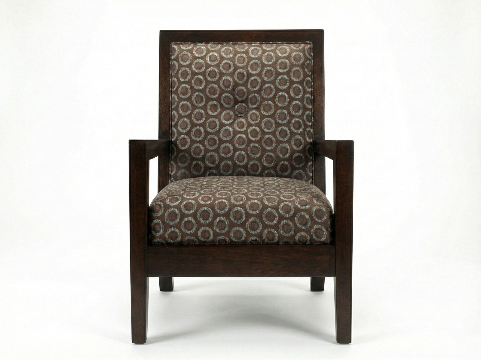 Front view of the Reese Easy Chair, a transitional armchair with a visible dark espresso-stained wooden frame. The frame has straight, blocky arms and legs. The back and seat cushions are upholstered in a boldly patterned fabric featuring concentric circles in shades of brown, gray, and tan, with a single button tuft on the back cushion. The chair is photographed against a plain white background