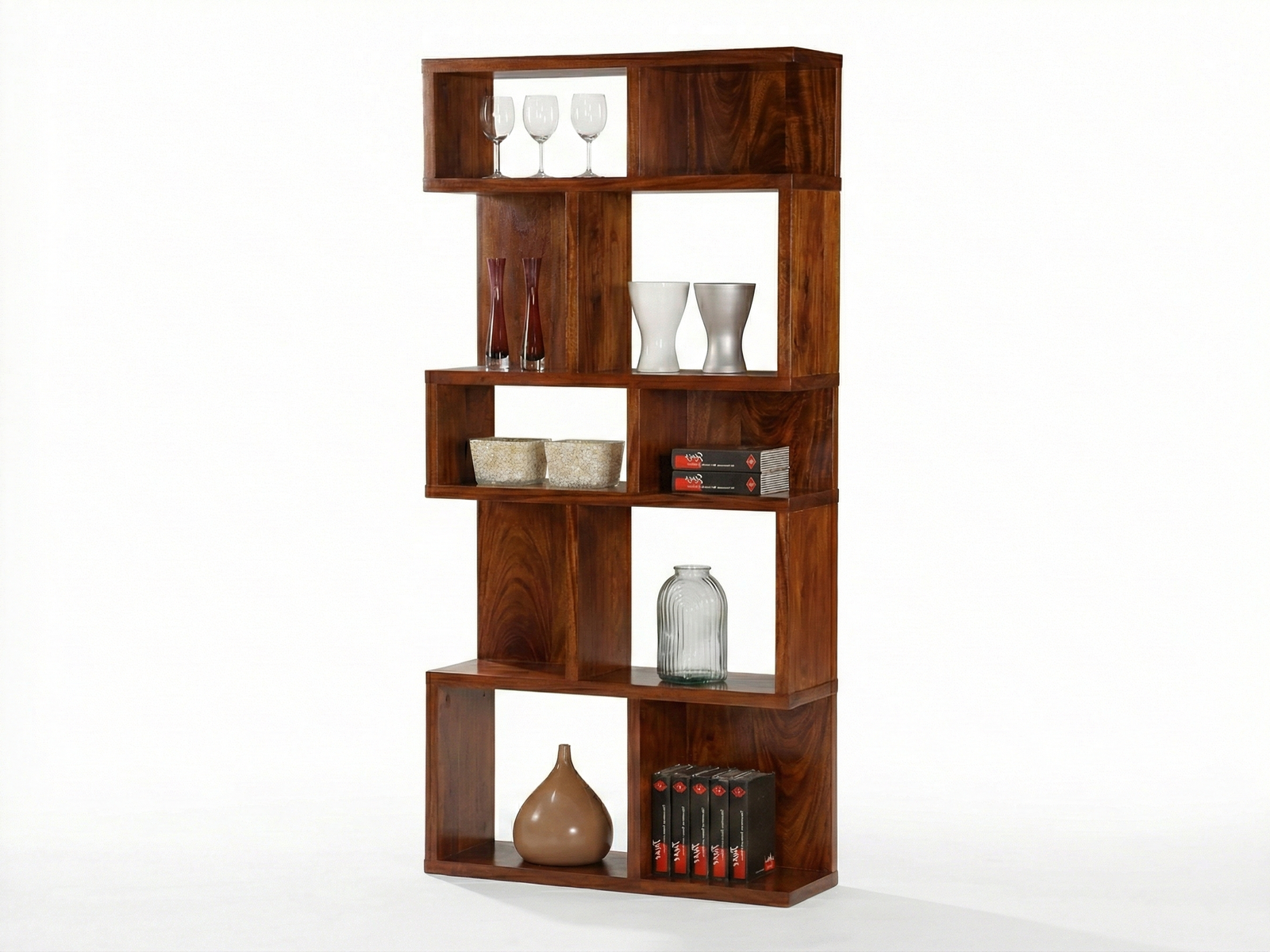 Side view of a tall, modern Brompton display unit or bookshelf made of dark, reddish-brown Mahogany wood. The unit has an asymmetrical, staggered, and geometric design, creating several open, rectangular shelves of varying sizes