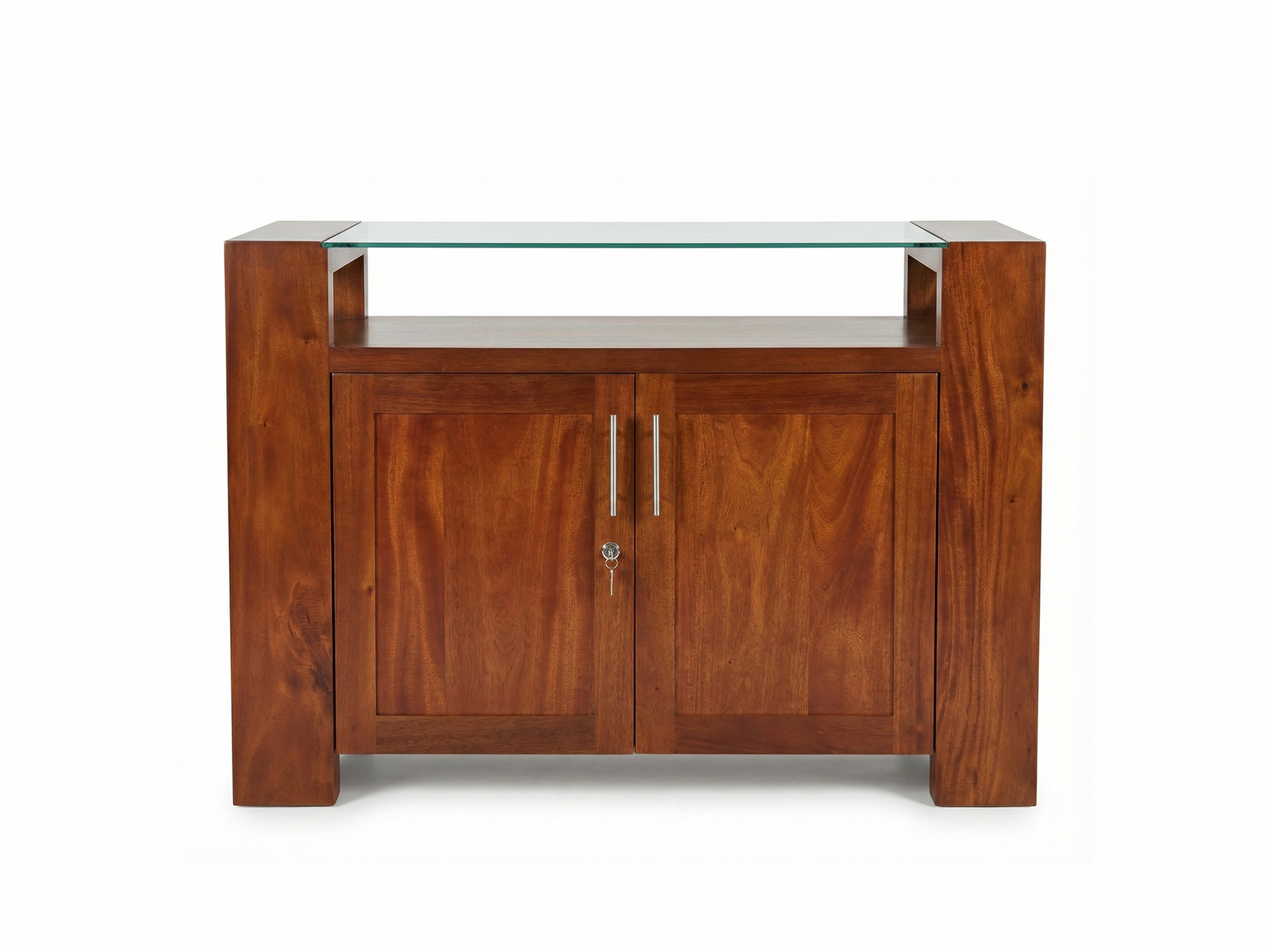 Front view of a rich, reddish-brown solid wood mahogany Exodus-GT Sideboard, featuring a thick rectangular frame. The piece has two lockable doors with a vertical grain pattern and is topped by a clear, tempered glass surface elevated above the main body