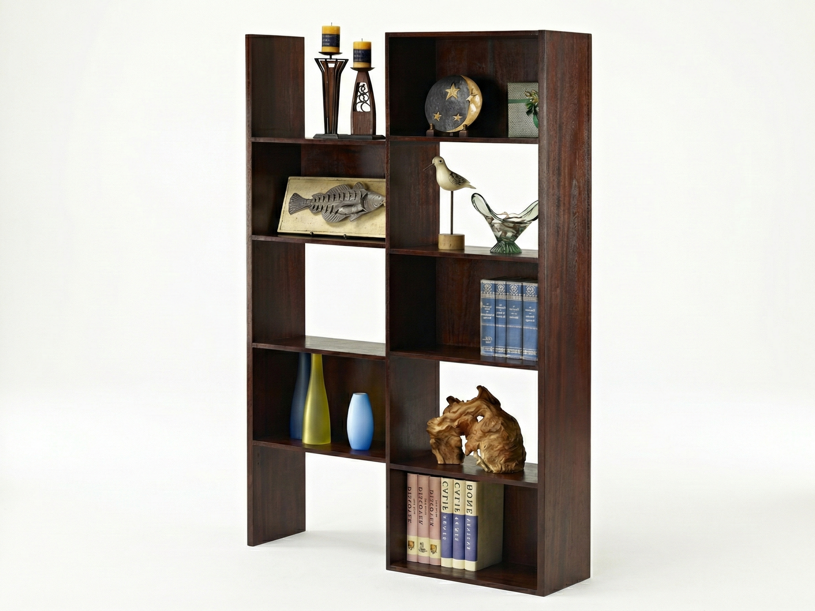 Side view of a tall, dark Mahogany wooden open-backed Harrow display unit or bookshelf featuring an asymmetric, modular design with multiple shelves. It is decorated with various objects