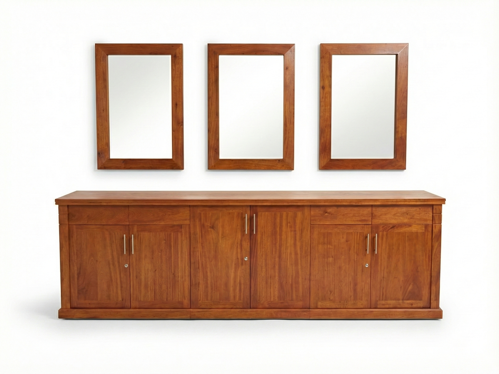 Front view of a classic wide, solid wood Jeremiah buffet cabinet with a warm, natural stain. The front is composed of three sections, each having one drawer and two doors, all using simple silver hardware. Above the cabinet hang three rectangular mirrors framed in the same wood