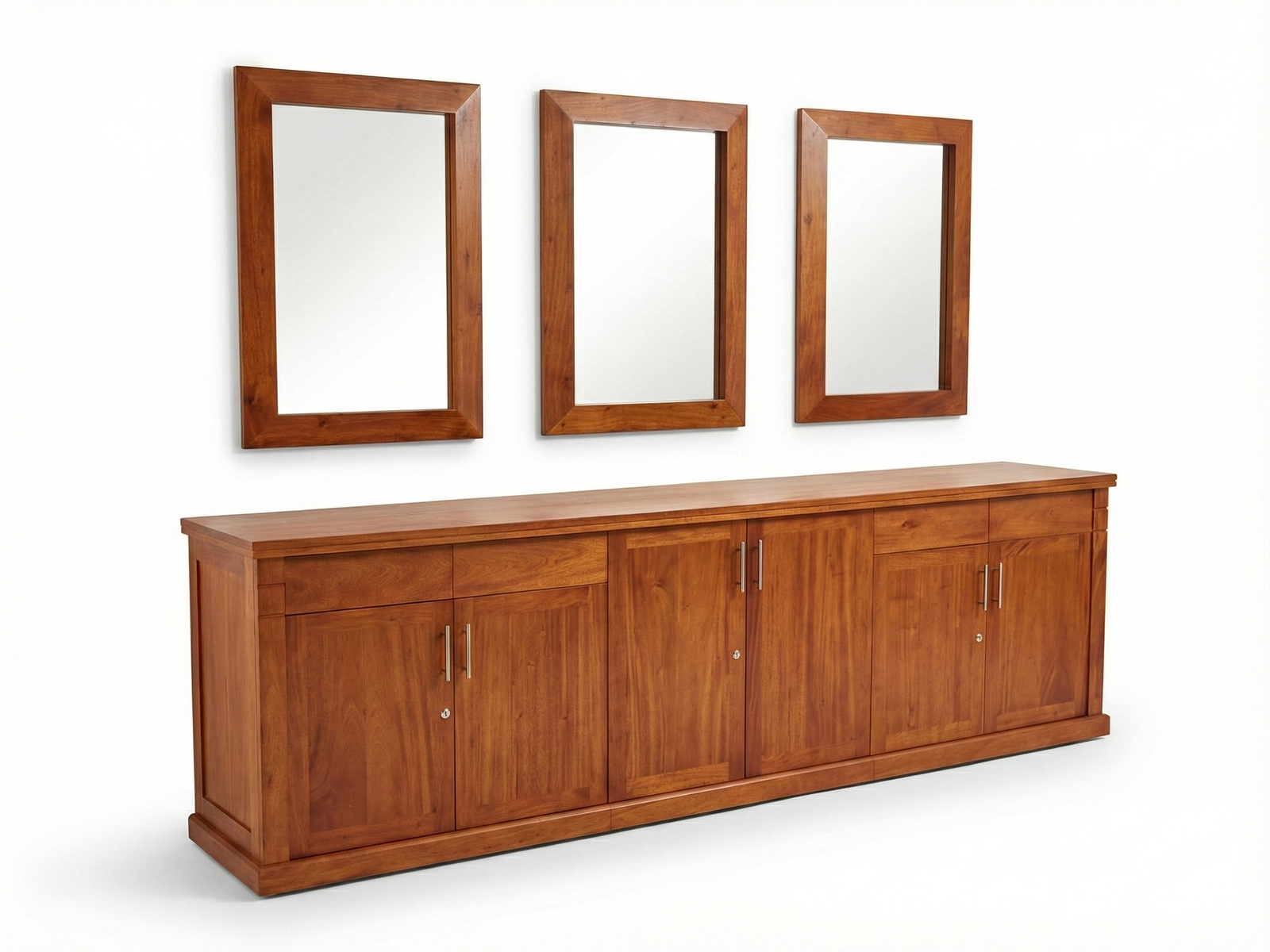 Side view of a classic wide, solid wood Jeremiah buffet cabinet with a warm, natural stain. The front is composed of three sections, each having one drawer and two doors, all using simple silver hardware. Above the cabinet hang three rectangular mirrors framed in the same wood