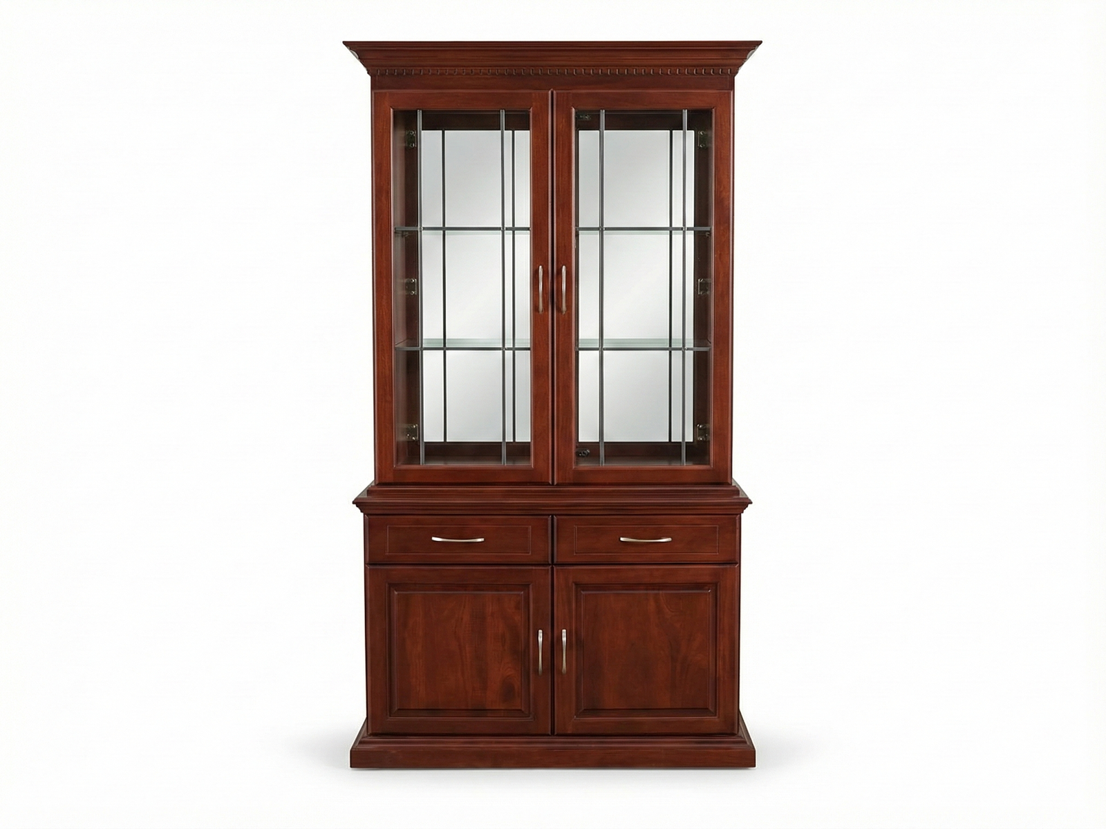 Front view of a tall, traditional wooden Kentone 2 Glass cabinet with a reddish-brown stain. The upper section features two glass-fronted doors and glass shelves. The base contains two drawers with silver handles above two solid wooden doors, all resting on a decorative base